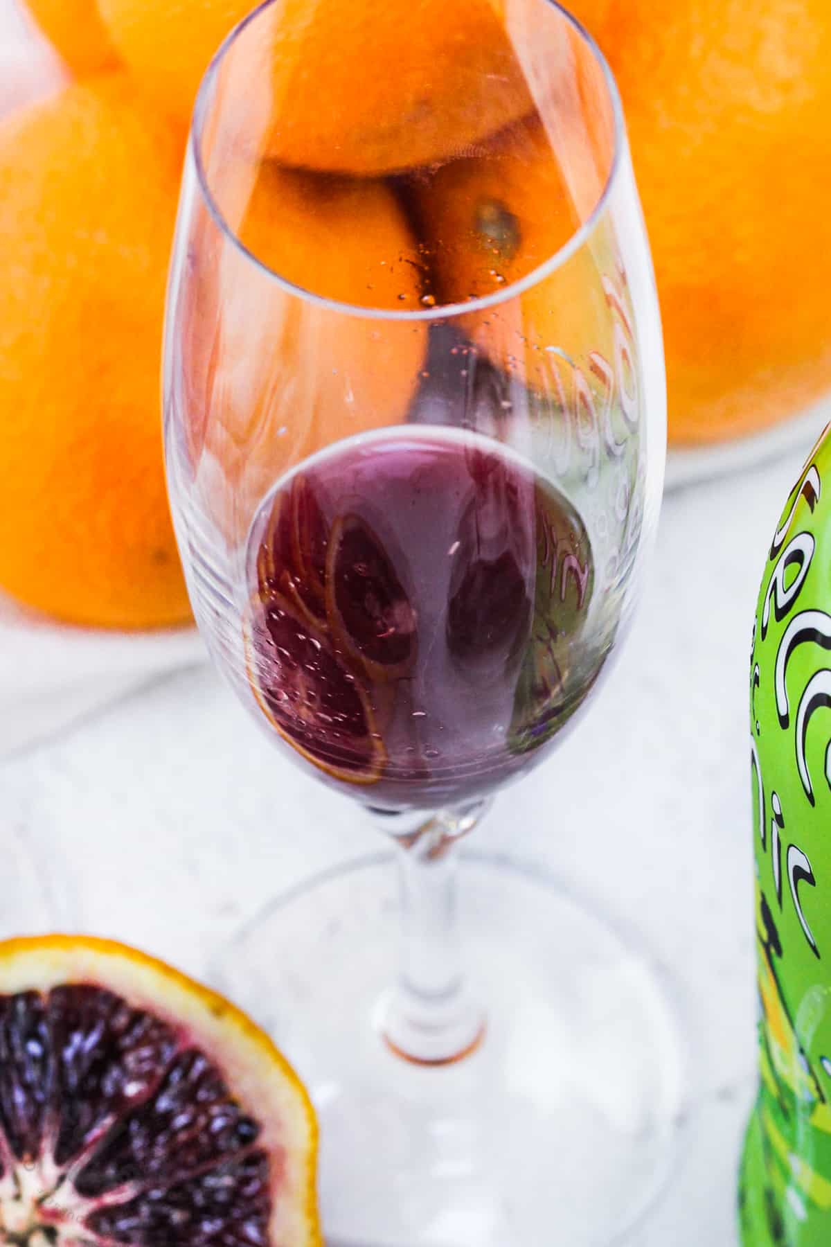 sparking wine in a glass to make Blood Orange Mimosa
