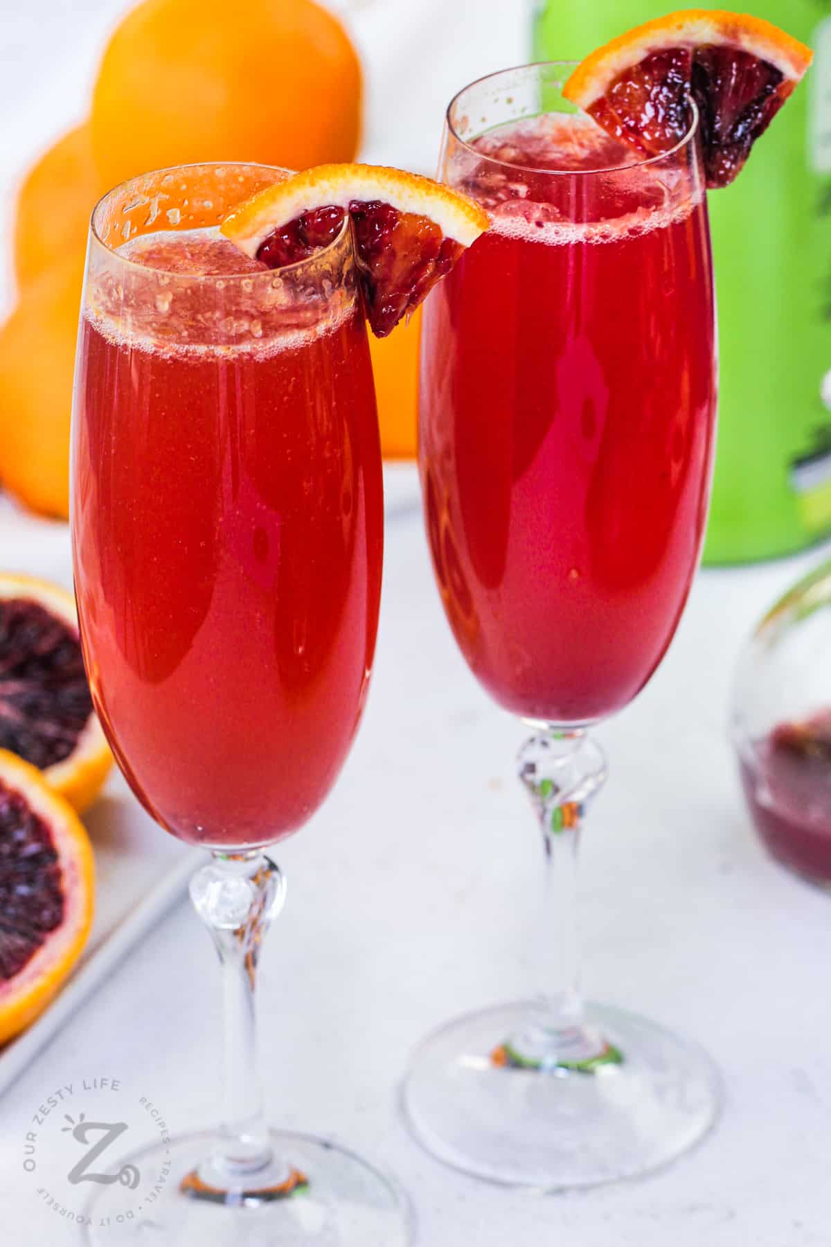 Blood Orange Mimosa with oranges in the back