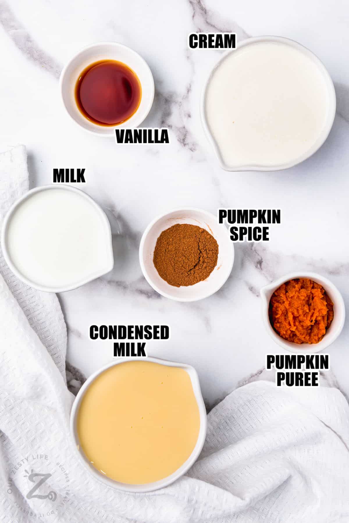 cream , vanilla , milk , pumpkin spice , pumpkin puree and condensed milk with labels to make Pumpkin Spice Creamer