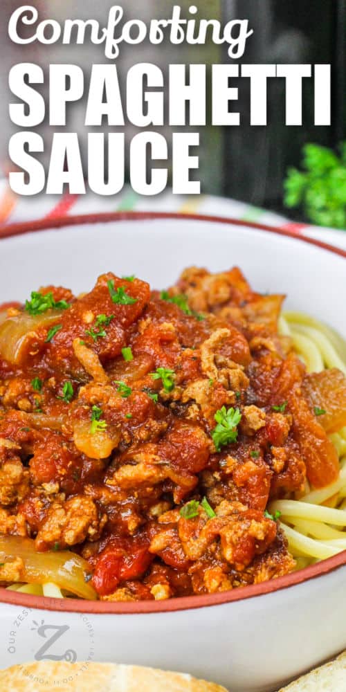 bowl of Slow Cooker Spaghetti Sauce with pasta and writing