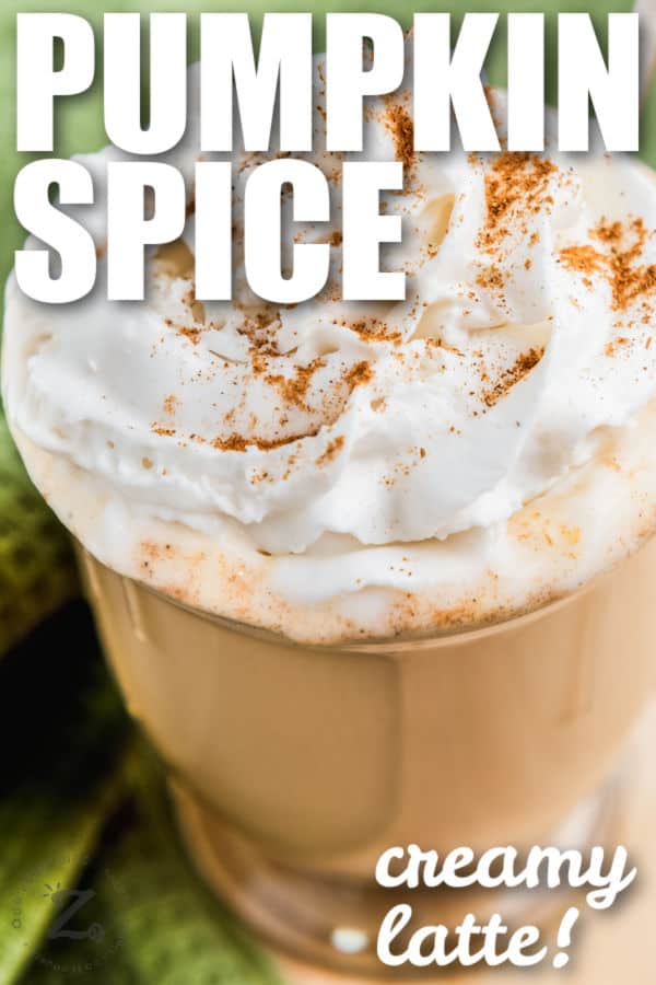 close up of Pumpkin Spice Latte with whipped cream and writing