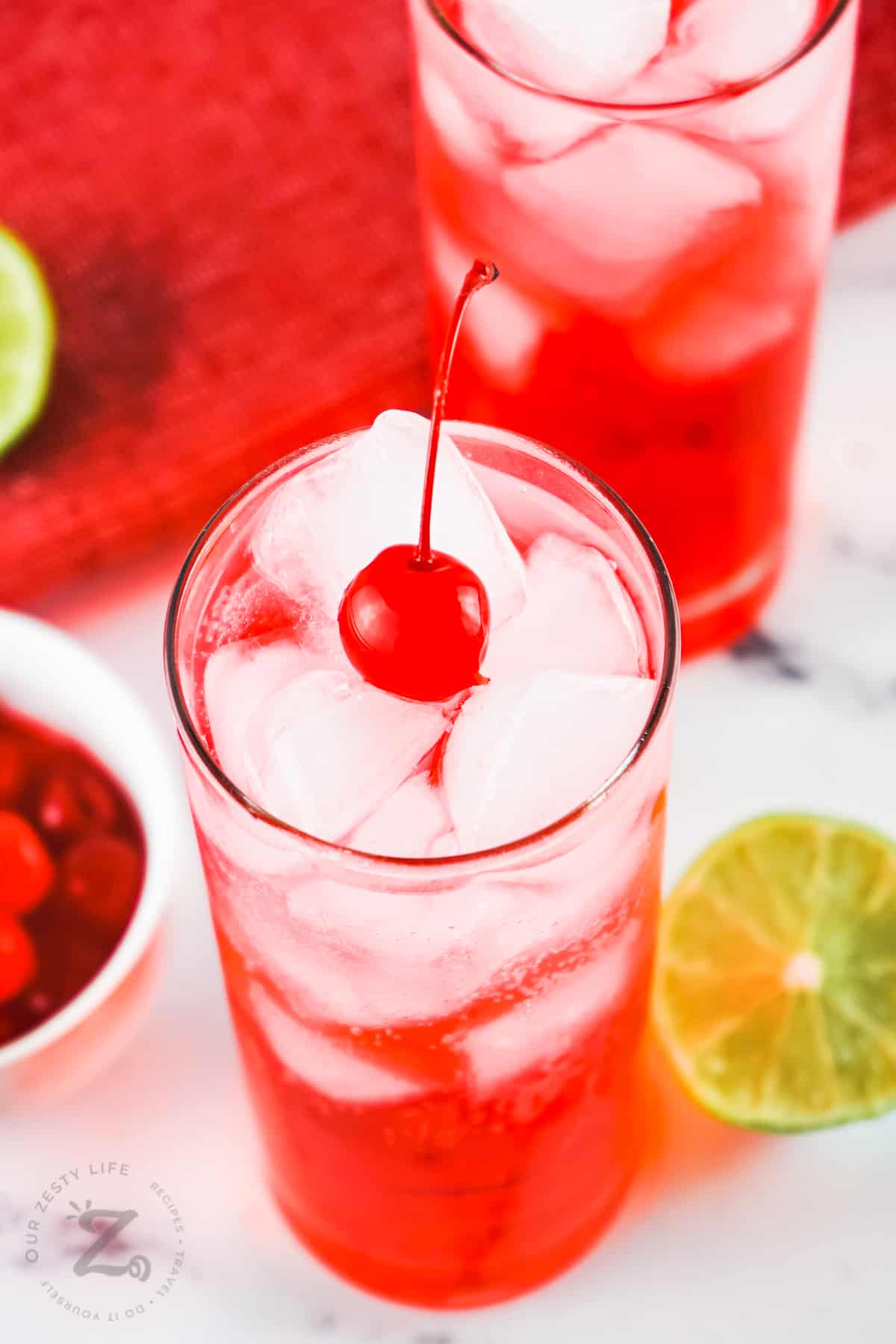 glasses of Shirley Temple with ice and cherries