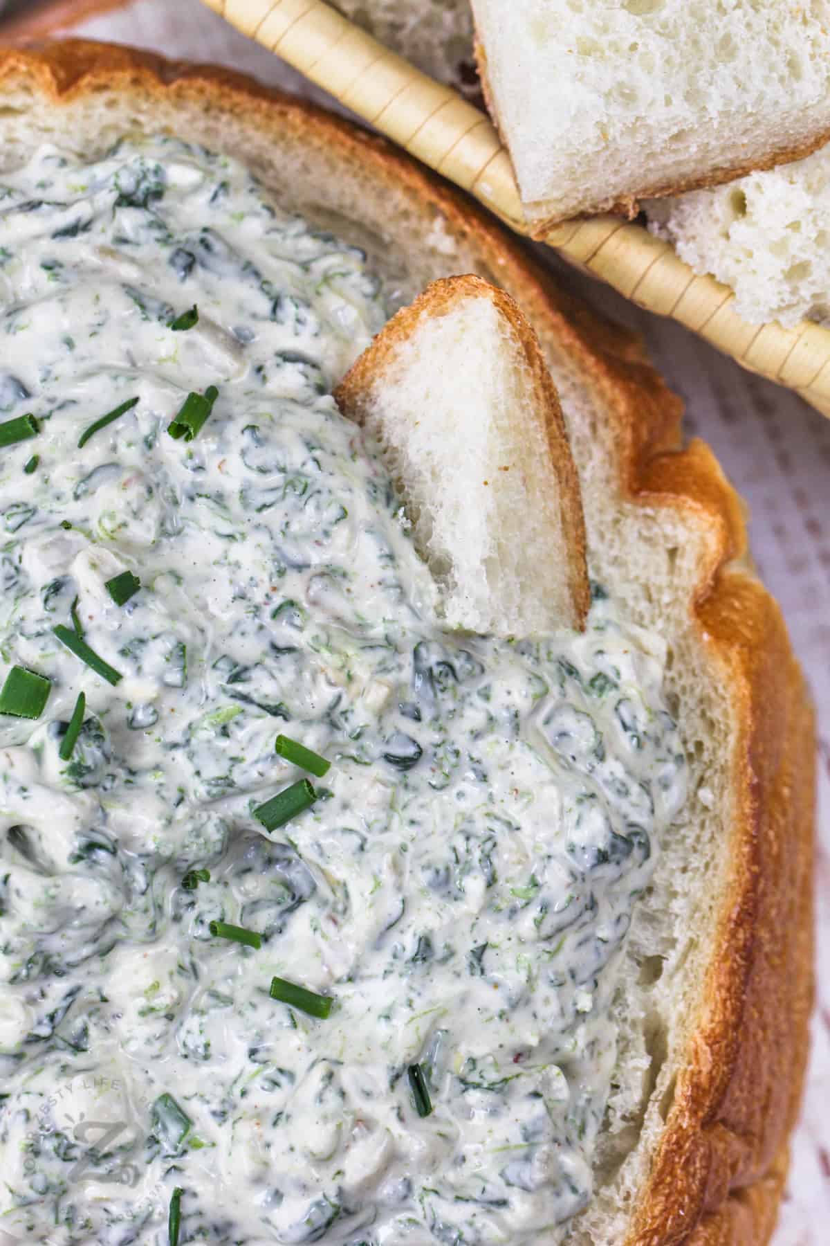 dipping bread in Spinach Dip