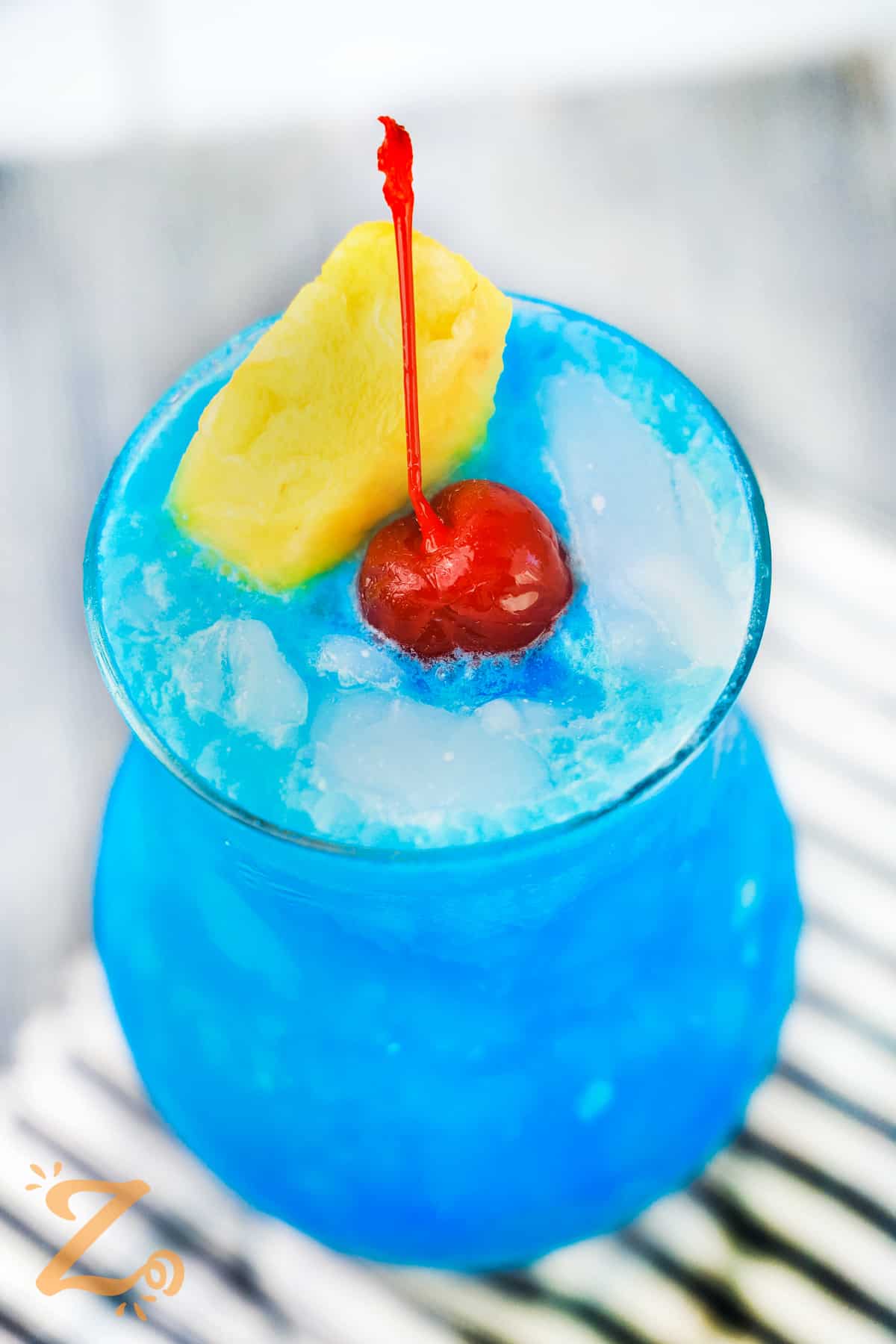 Blue Hawaiian Cocktail with pineapple and cherry