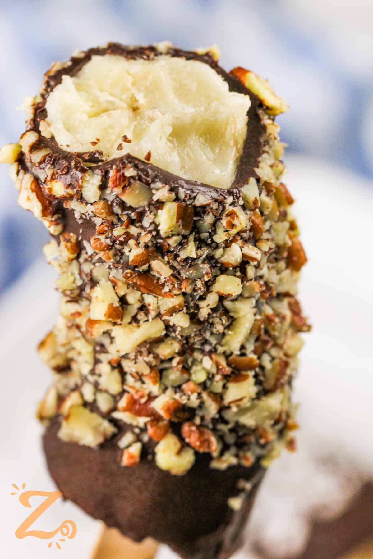 close up of Frozen Chocolate Covered Bananas with chopped nuts