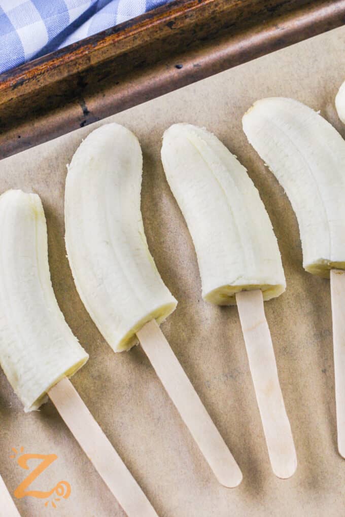 bananas on popsicle sticks to make Frozen Chocolate Covered Bananas