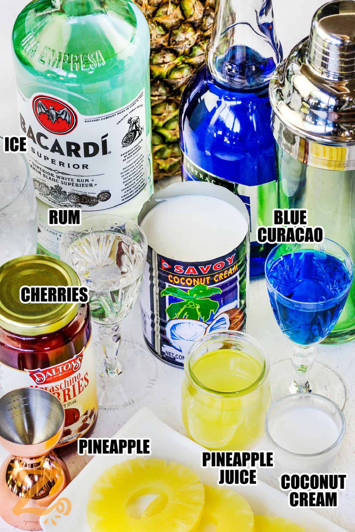 ice , rum , cherries , pineapple , pineapple juice , coconut cream , blue curacao with labels to make Blue Hawaiian Cocktail
