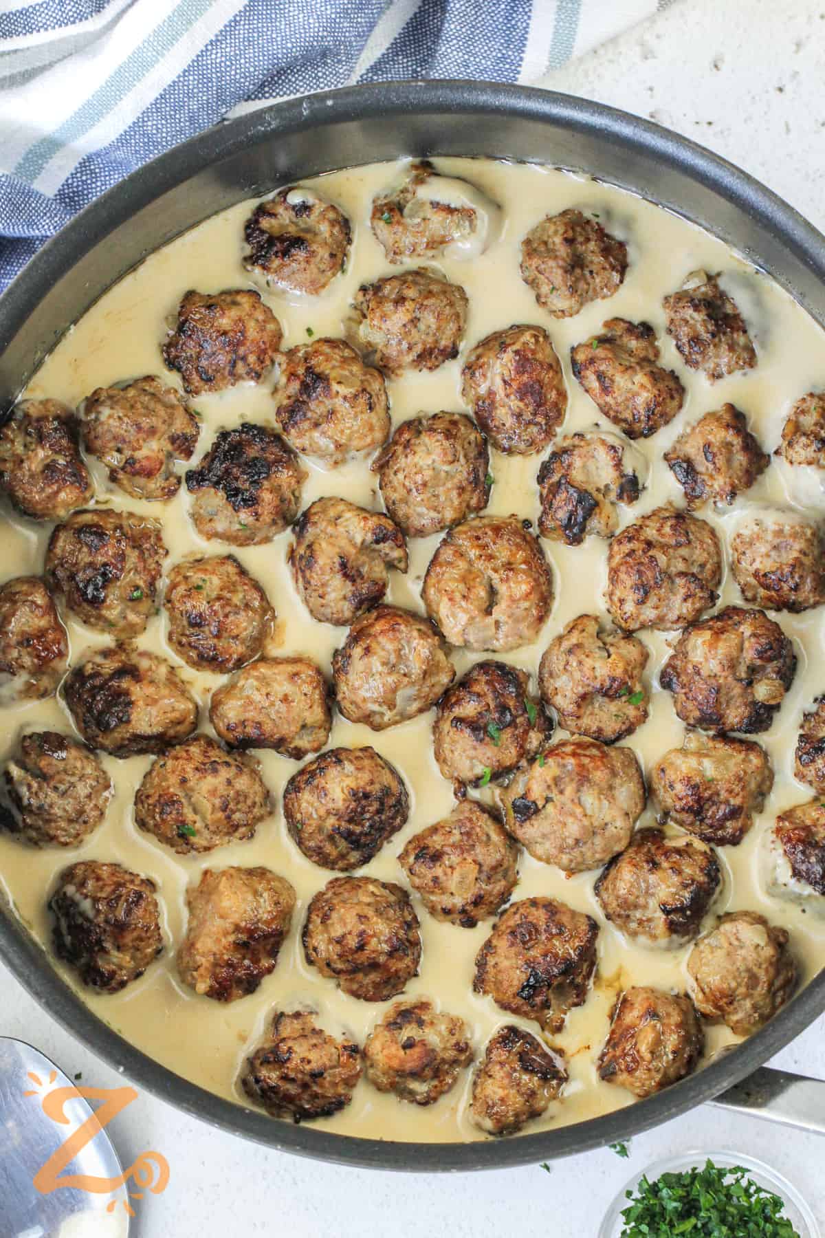 adding meatballs to sauce to make Swedish Meatballs