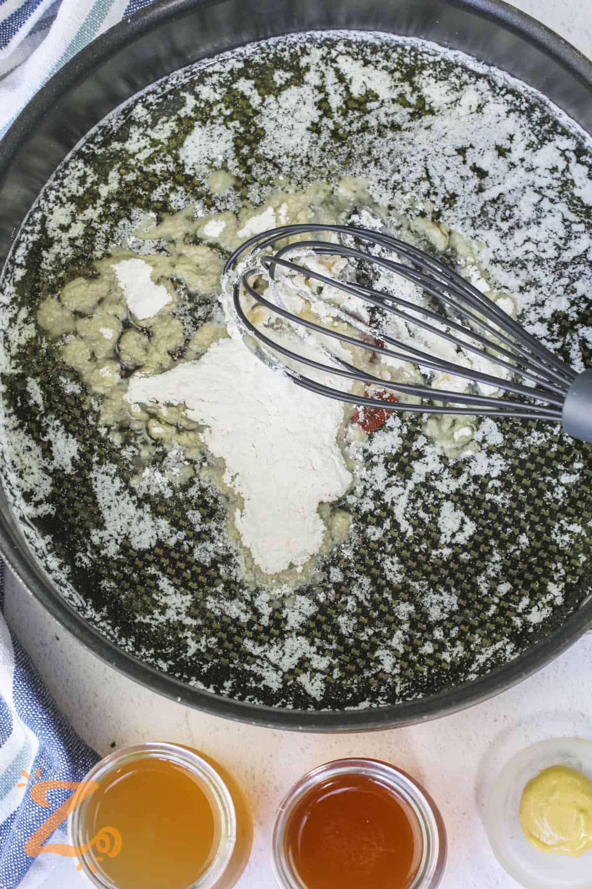 adding flour to pan to make sauce for Swedish Meatballs