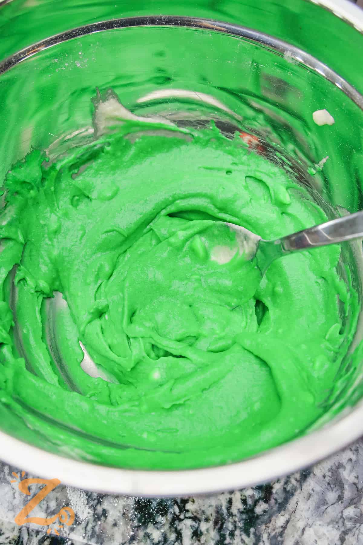 green cake batter in a bowl to make Watermelon Cupcakes