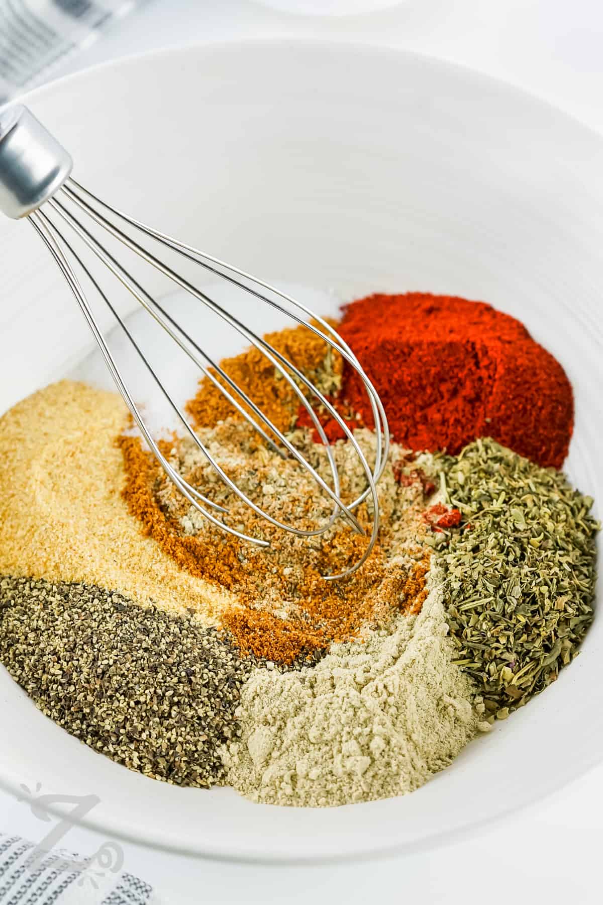 mixing spices together to make Cajun Seasoning