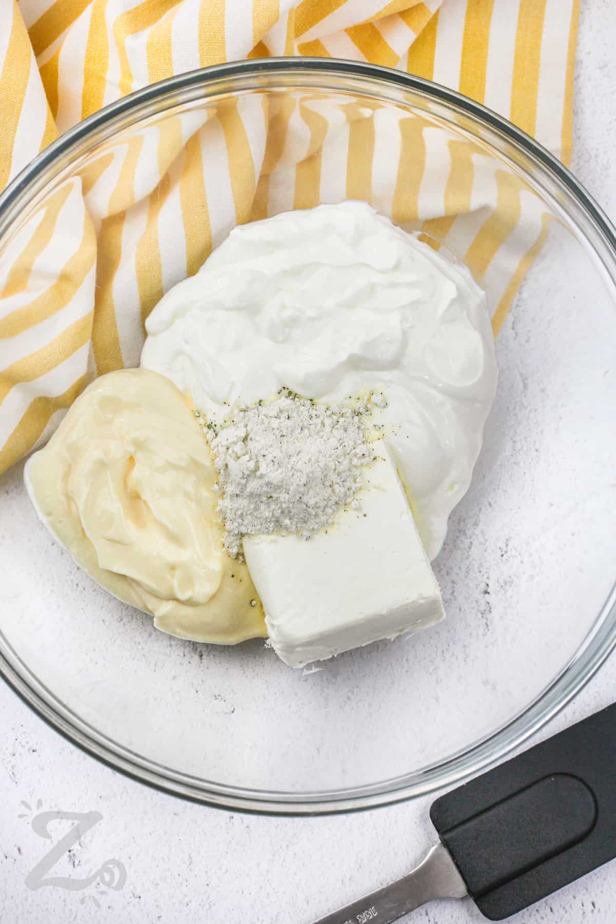 adding seasonings with mayo , cream cheese and sour cream