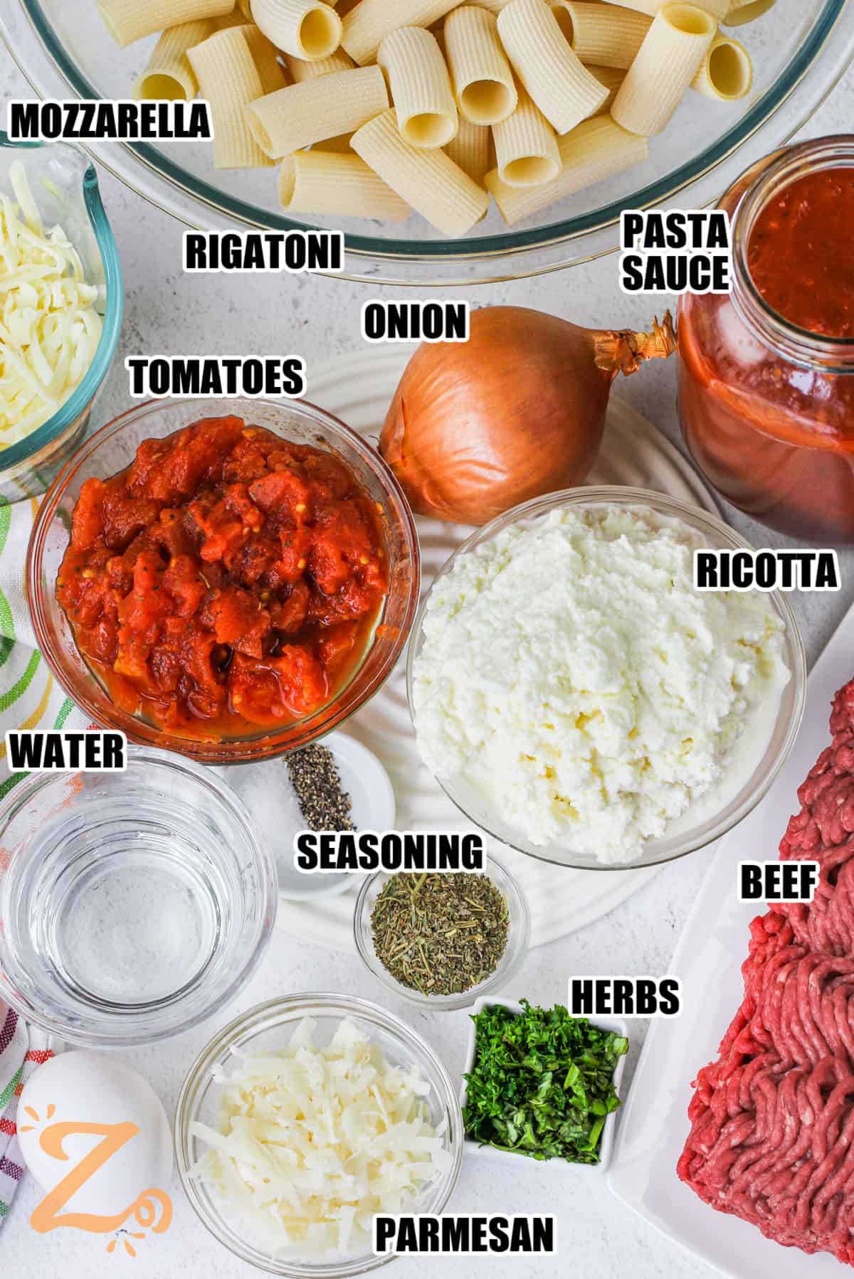 mozzarella , rigatoni , onion , pasta sauce , tomatoes , ricotta , seasonings , water , parmesan , herbs and beef to make Baked Rigatoni with labels