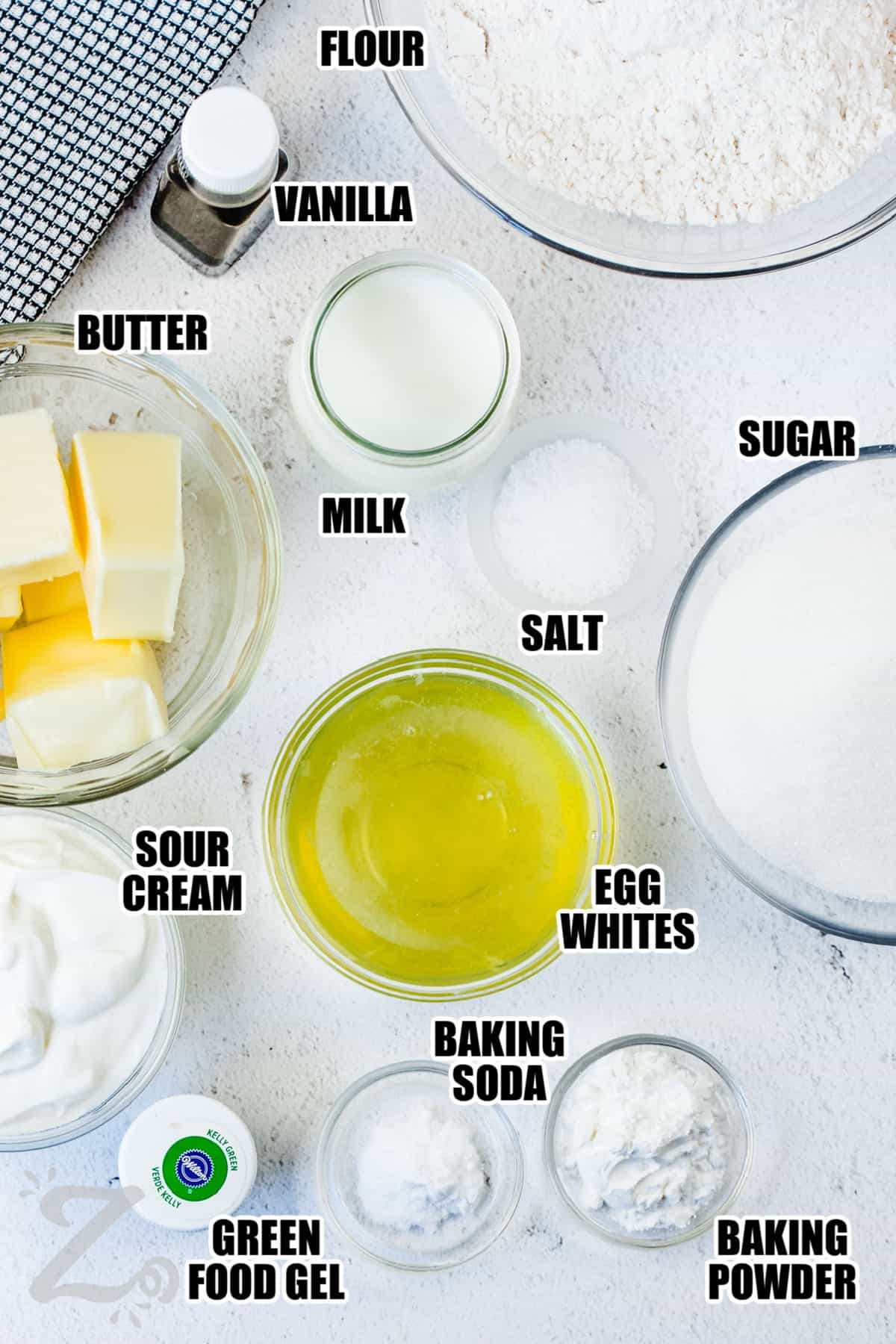 flour , vanilla , butter , milk , sugar , salt , egg whites , sour cream , baking soda , baking powder and green food gel with labels to make Watermelon Cupcakes