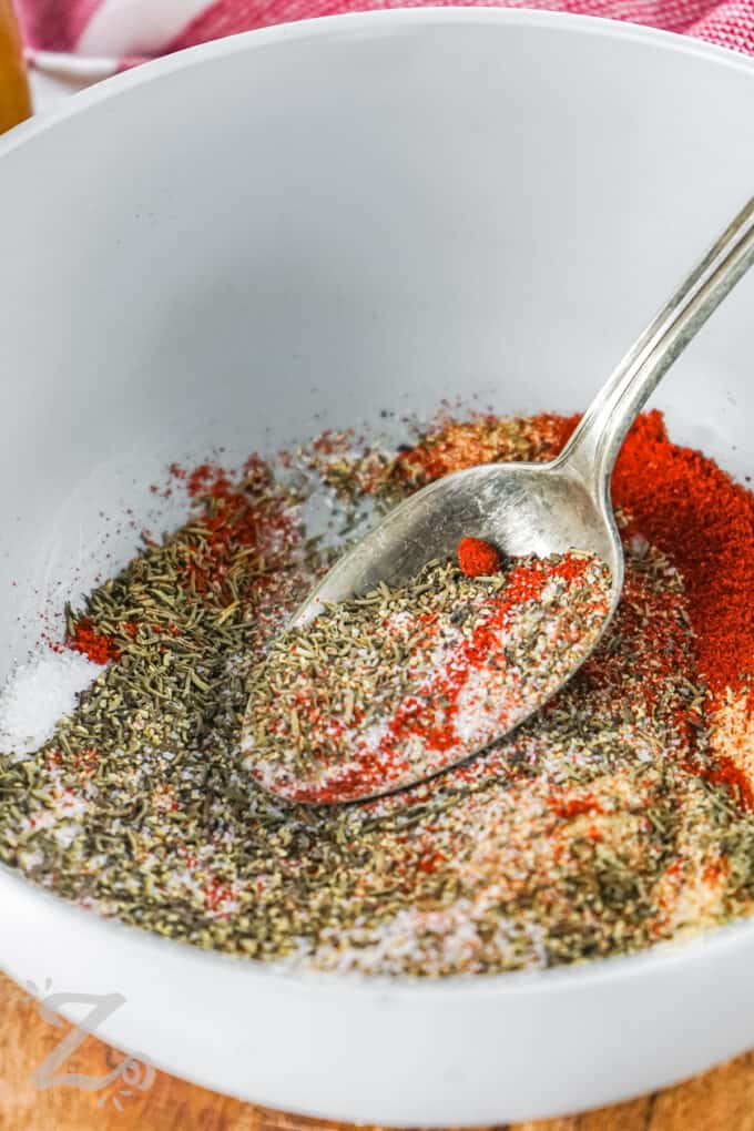 mixing spices together to make Steak Seasoning