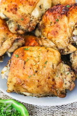 Baked Chicken Thighs on a plate with garnish