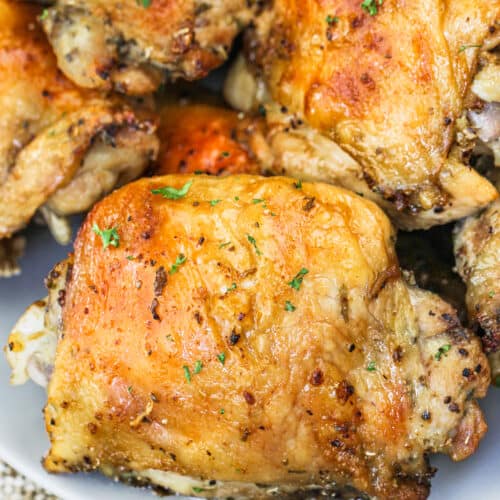Baked Chicken Thighs on a plate with garnish