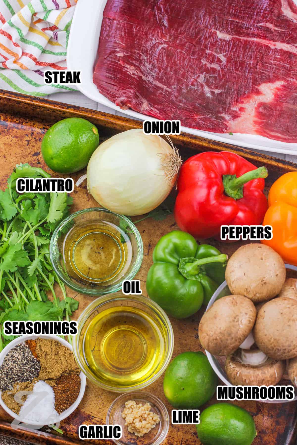 steak , onion , cilantro , peppers , oil , seasonings , mushrooms , lime and garlic with labels to make Steak Fajitas