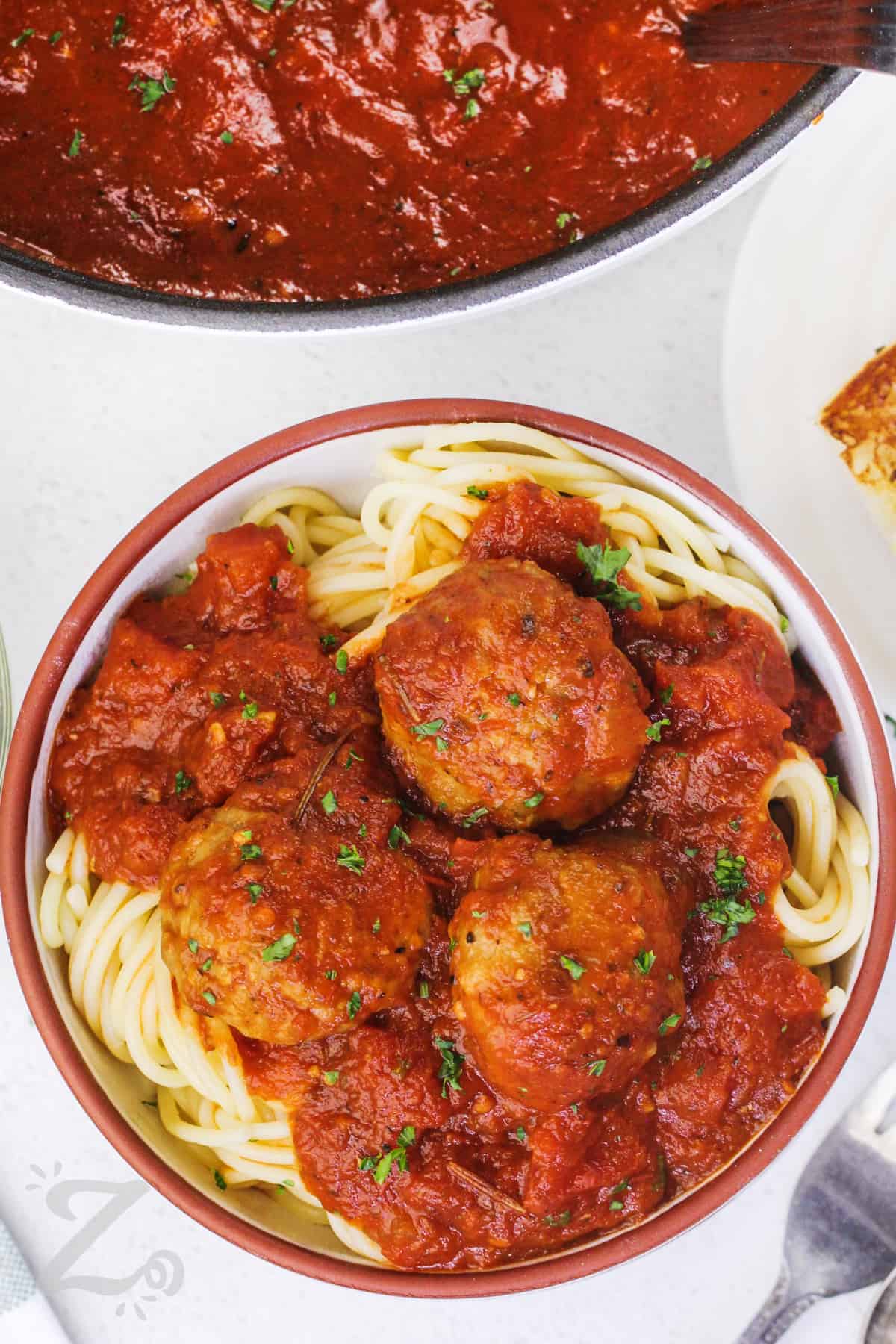 meatballs and sauce served over spaghetti in a bowl