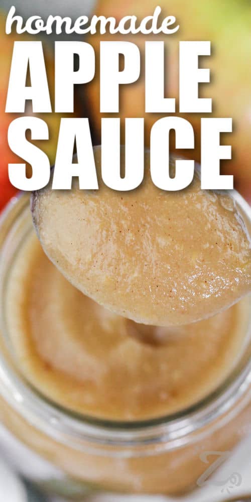 smooth apple sauce being scooped out of a jar with text.