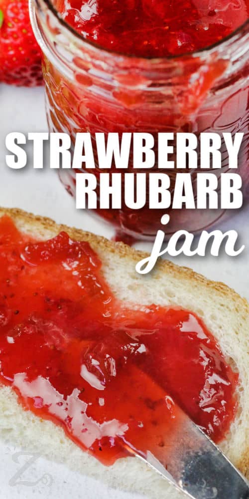 close up of spreading Strawberry Rhubarb Jam on bread with writing