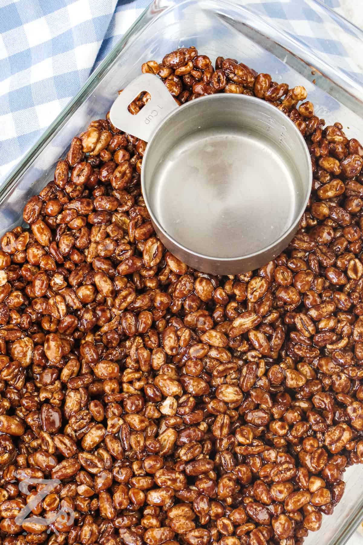 puffed wheat mixture being pressed into a pan