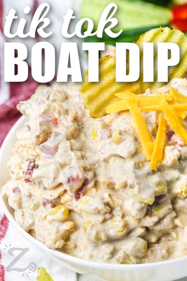 Boat Dip with chips and cheese on top, with a title