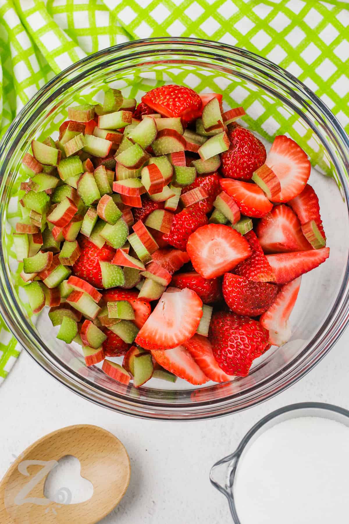strawberries and rhubarb sliced in a bowl to make Strawberry Rhubarb Jam