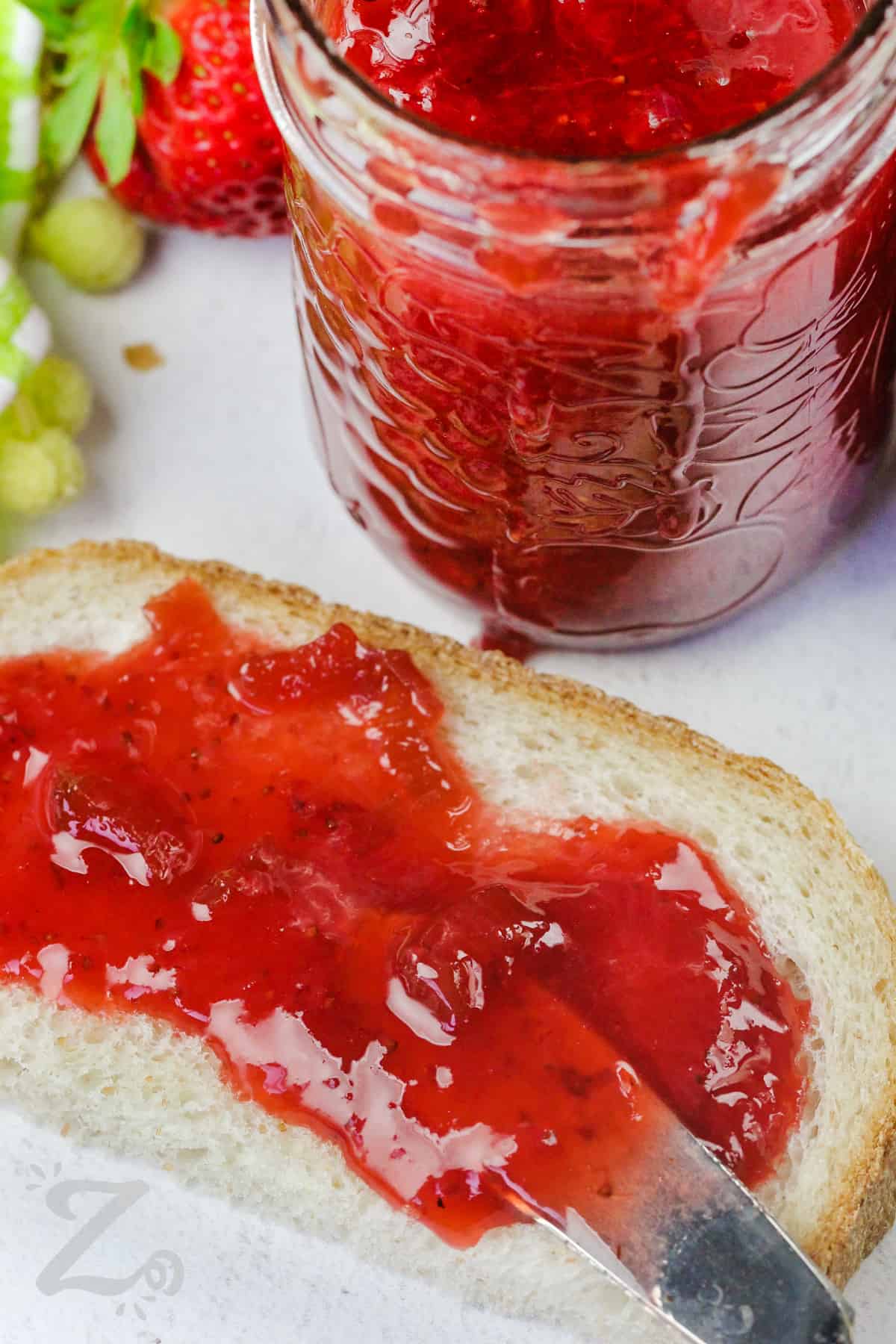 spreading Strawberry Rhubarb Jam on bread