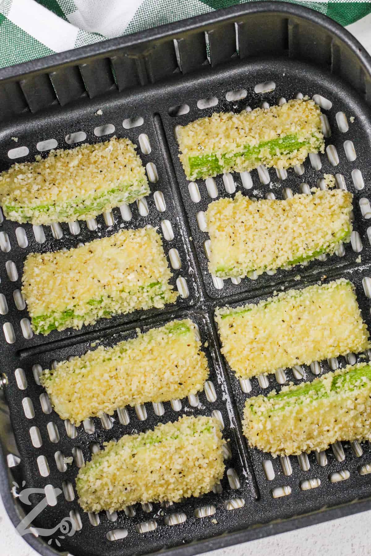breaded zucchini sticks in an air fryer basket
