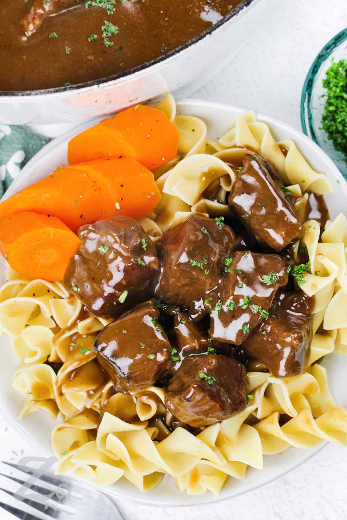 beef tips with gravy served over noodles