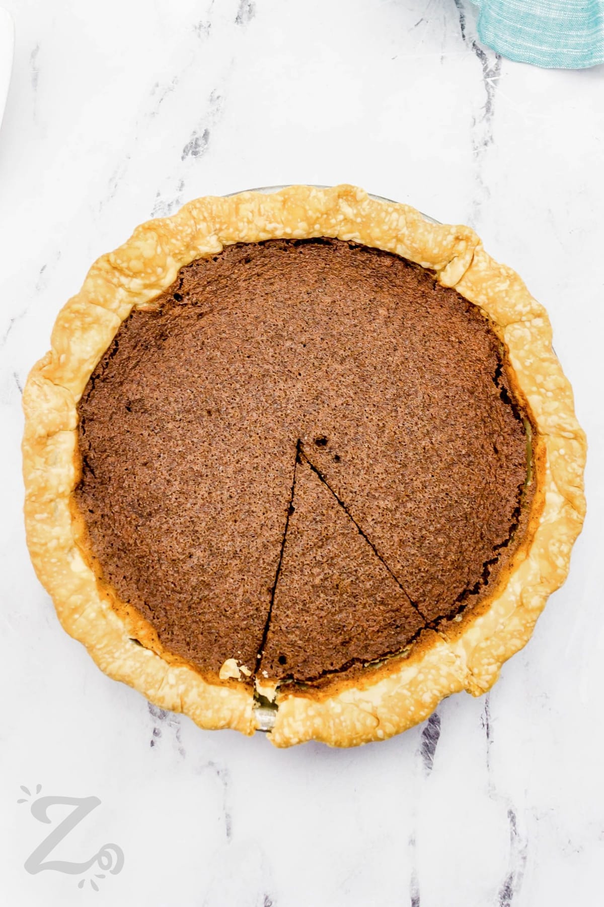 A slice cut out of a chocolate chess pie