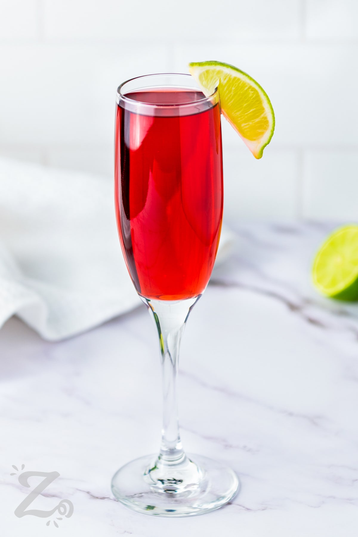 Cranberry Mimosas with a lime wedge