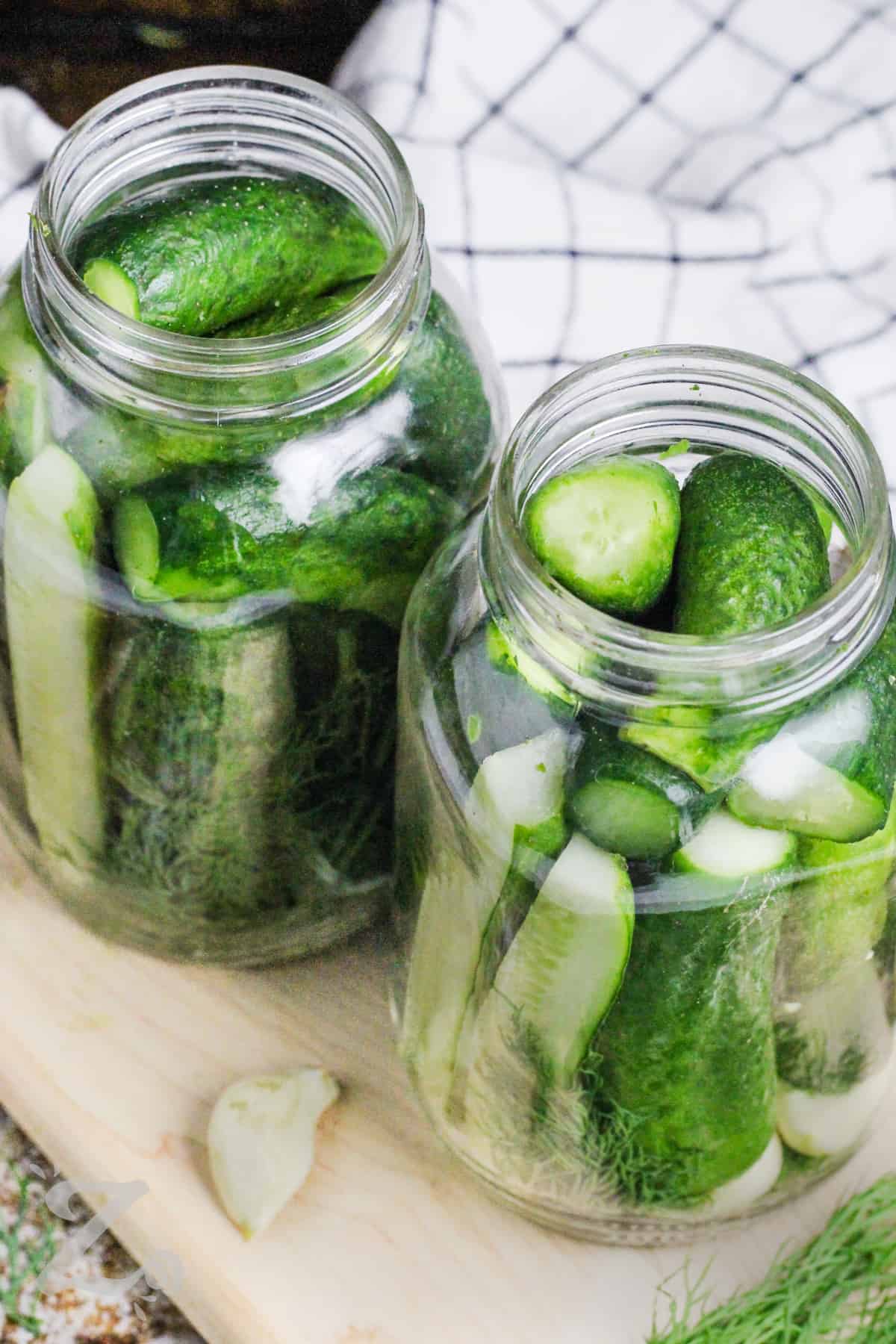 Dill pickles prepped in a jar.