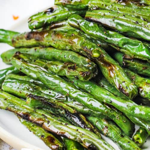 a serving dish of grilled green beans