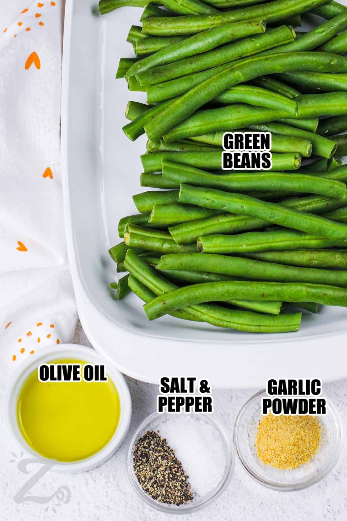 ingredients to make grilled green beans labeled: green beans, olive oil, salt and pepper, garlic powder