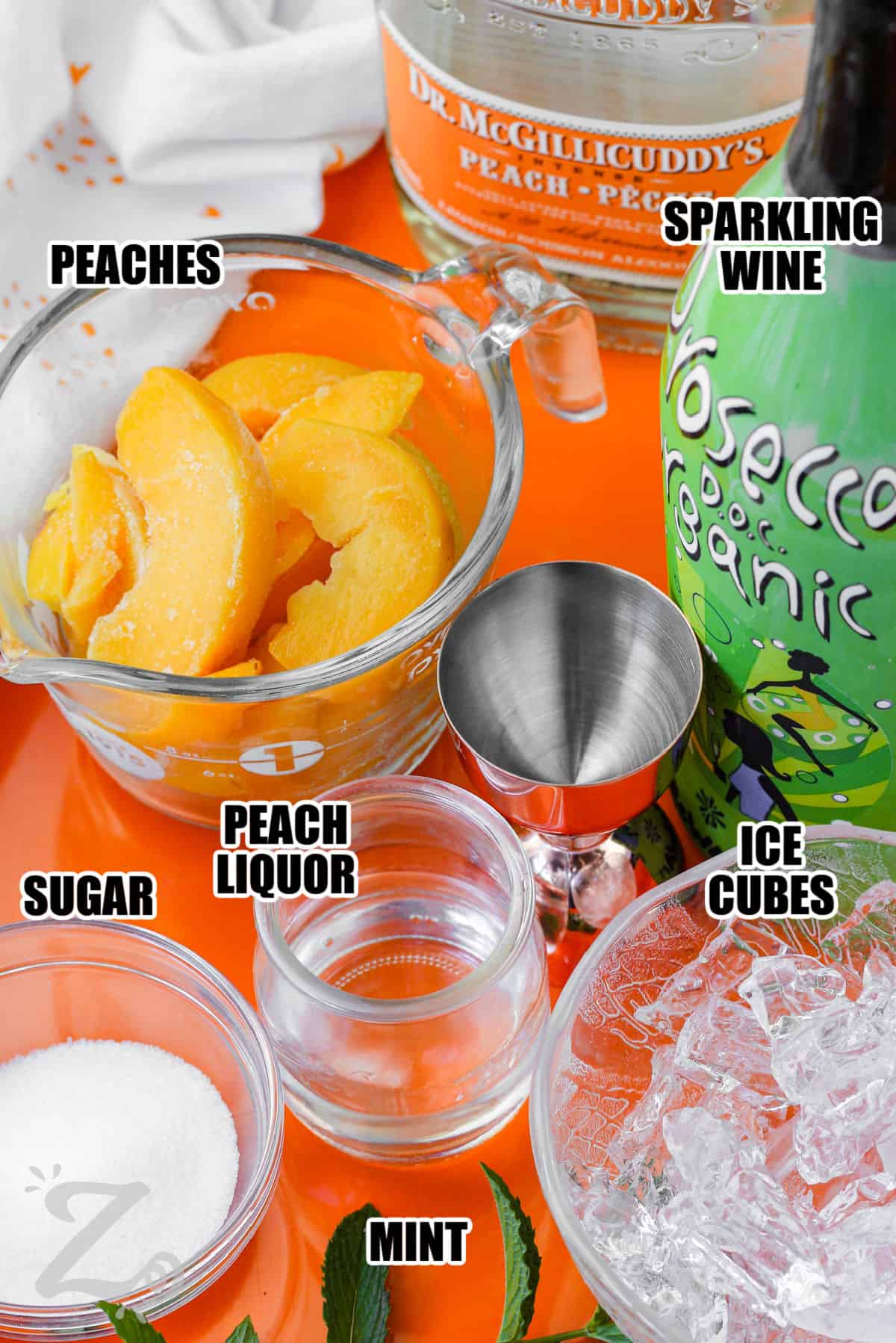 ingredients to make a peach bellini labeled