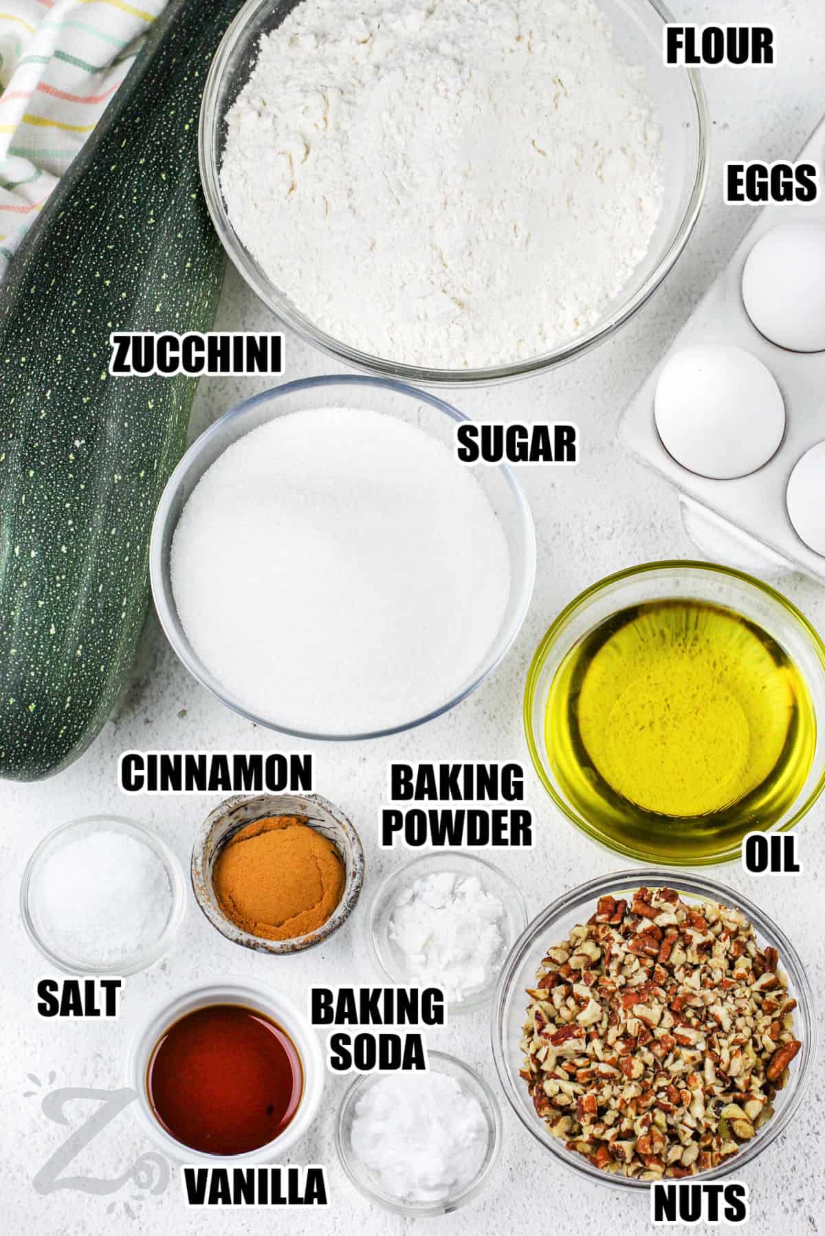 zucchini , sugar , flour , eggs , oil , baking powder , cinnamon , salt , baking soda , vanilla and nuts with labels to make Zucchini Bread