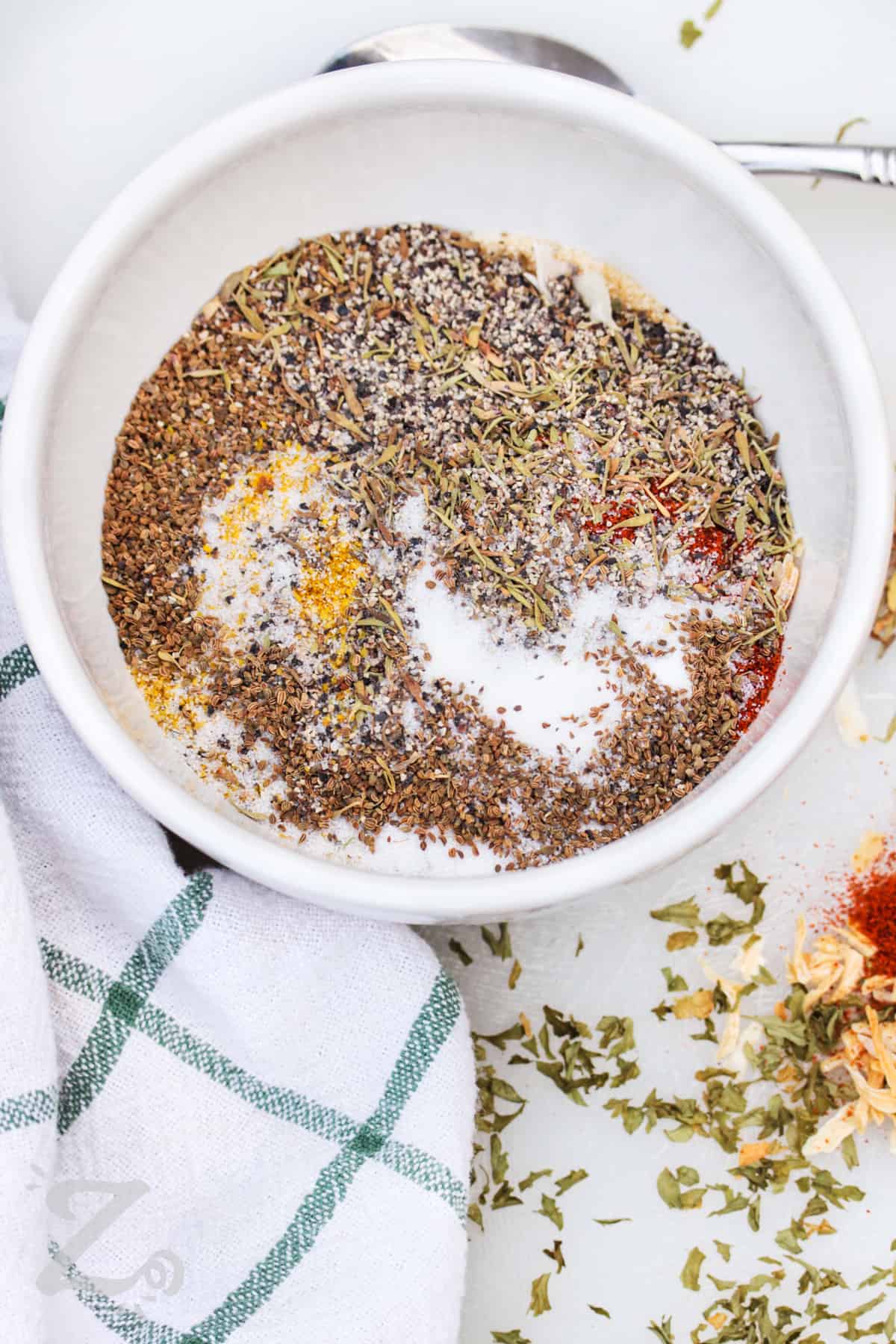 adding spices to bowl to make Italian Dressing Mix