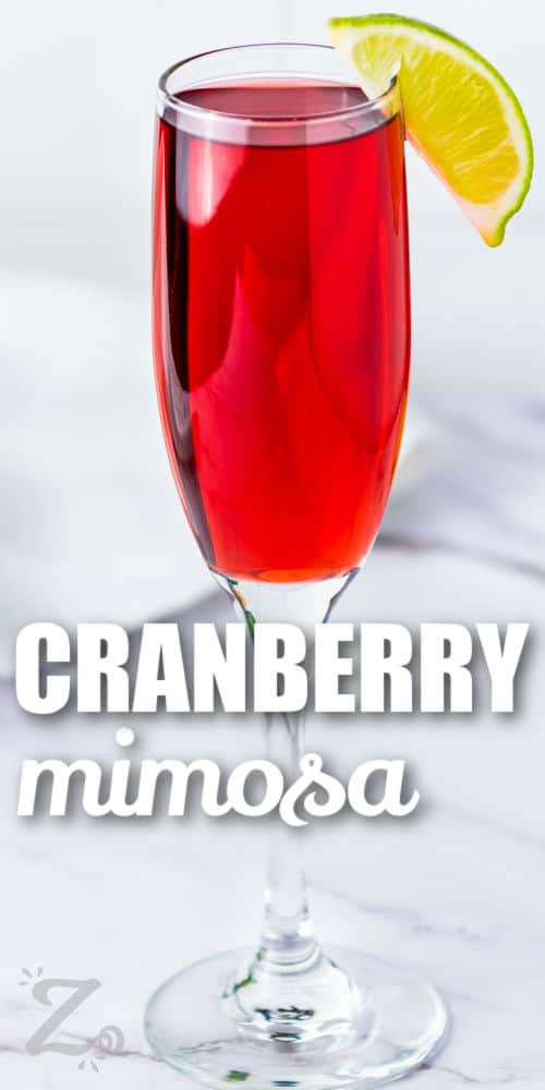 champagne glass with Cranberry Mimosa and a title