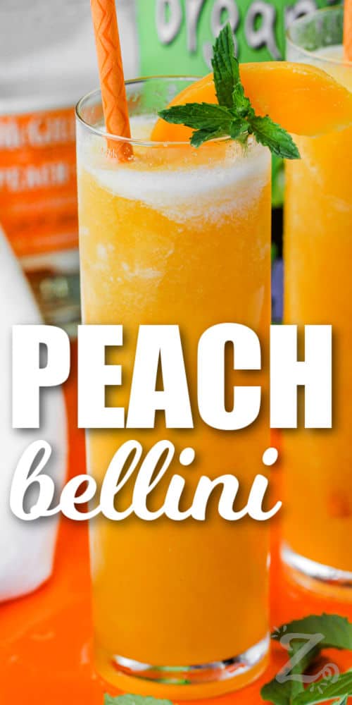 a tall glass of peach bellini with a peach slice on top and mint leaves with text