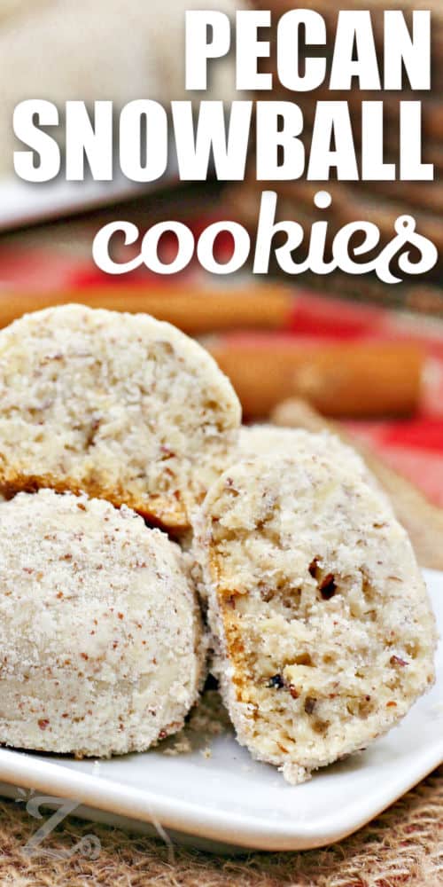 baked Pecan Snowball Cookies on a plate with writing