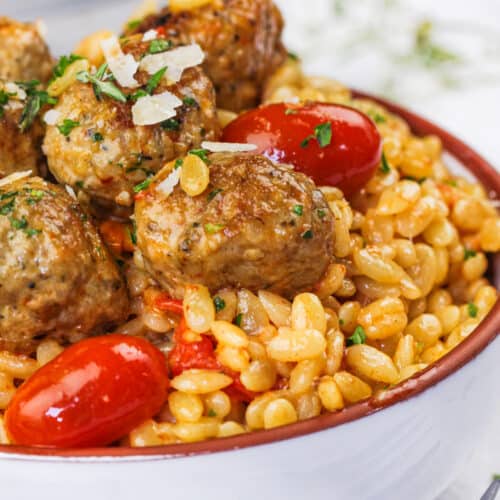 close up of plated One Pot Tomato Orzo With Meatballs