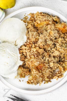 Pear crisp on a plate served with ice cream