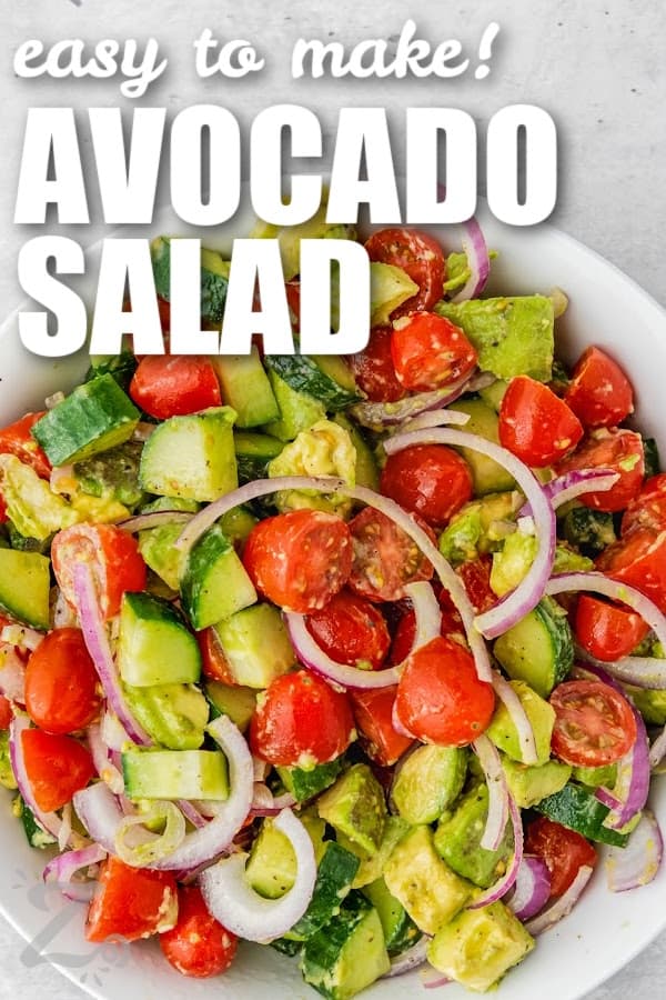 A bowl of prepared avocado salad with text