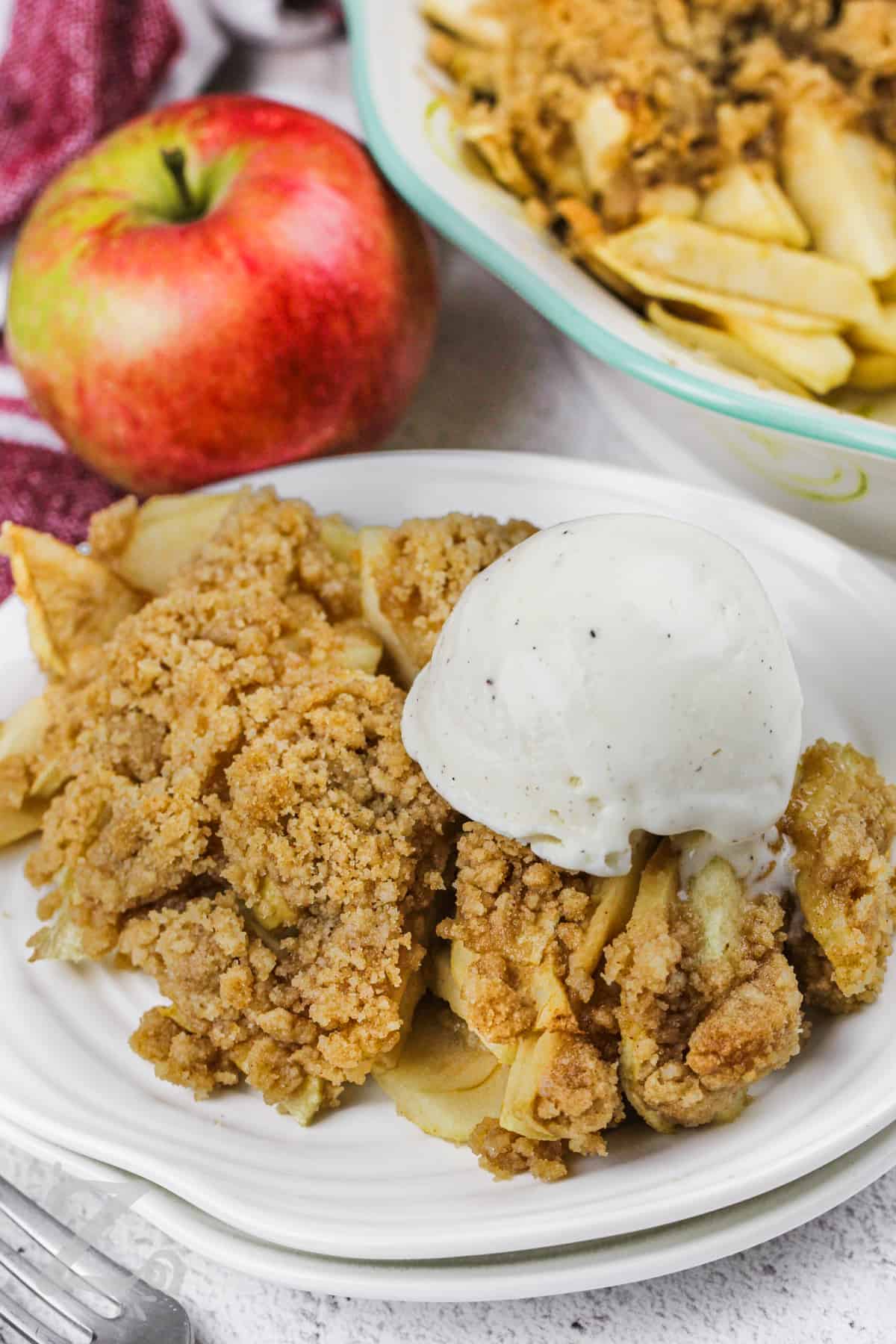 Apple Crumble with a scoop of ice cream on a plate