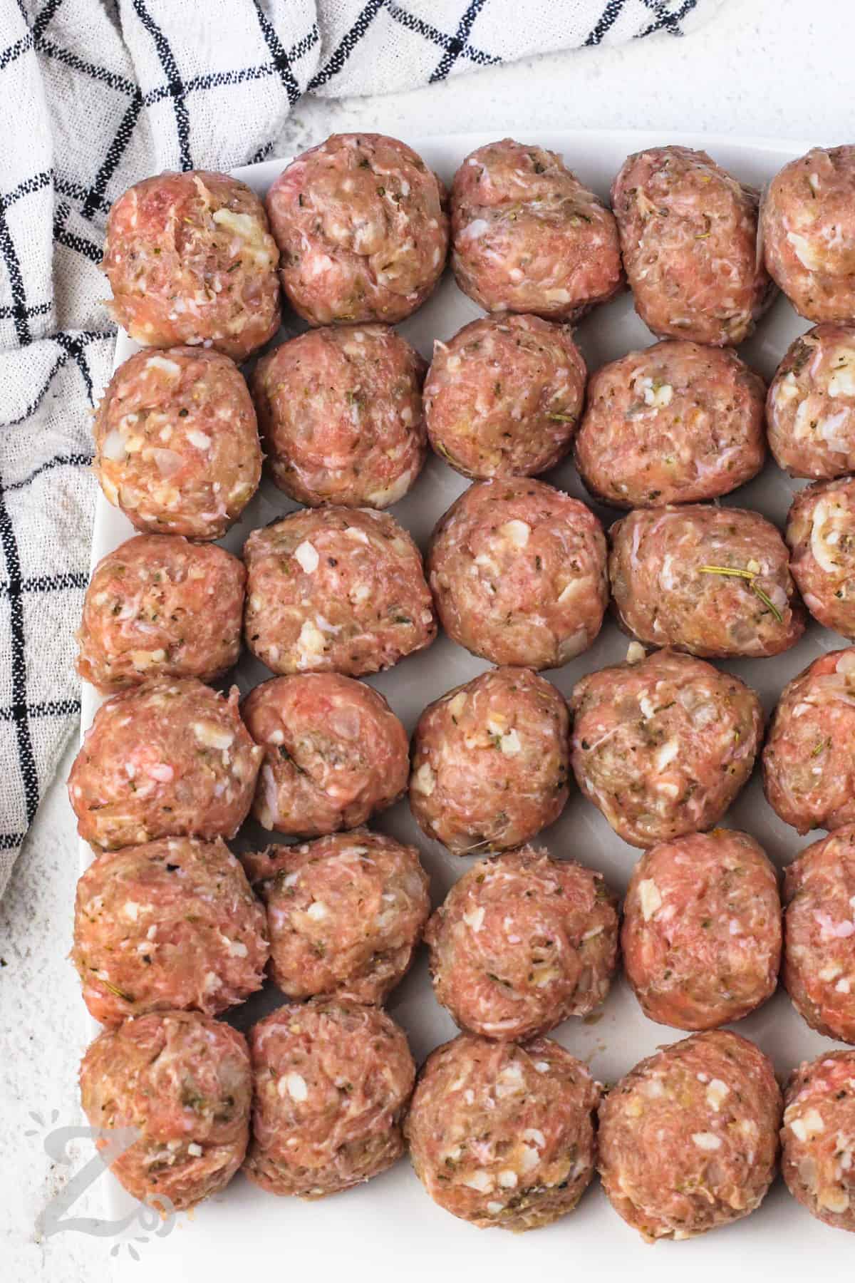 Chicken meatballs on a plate before being baked