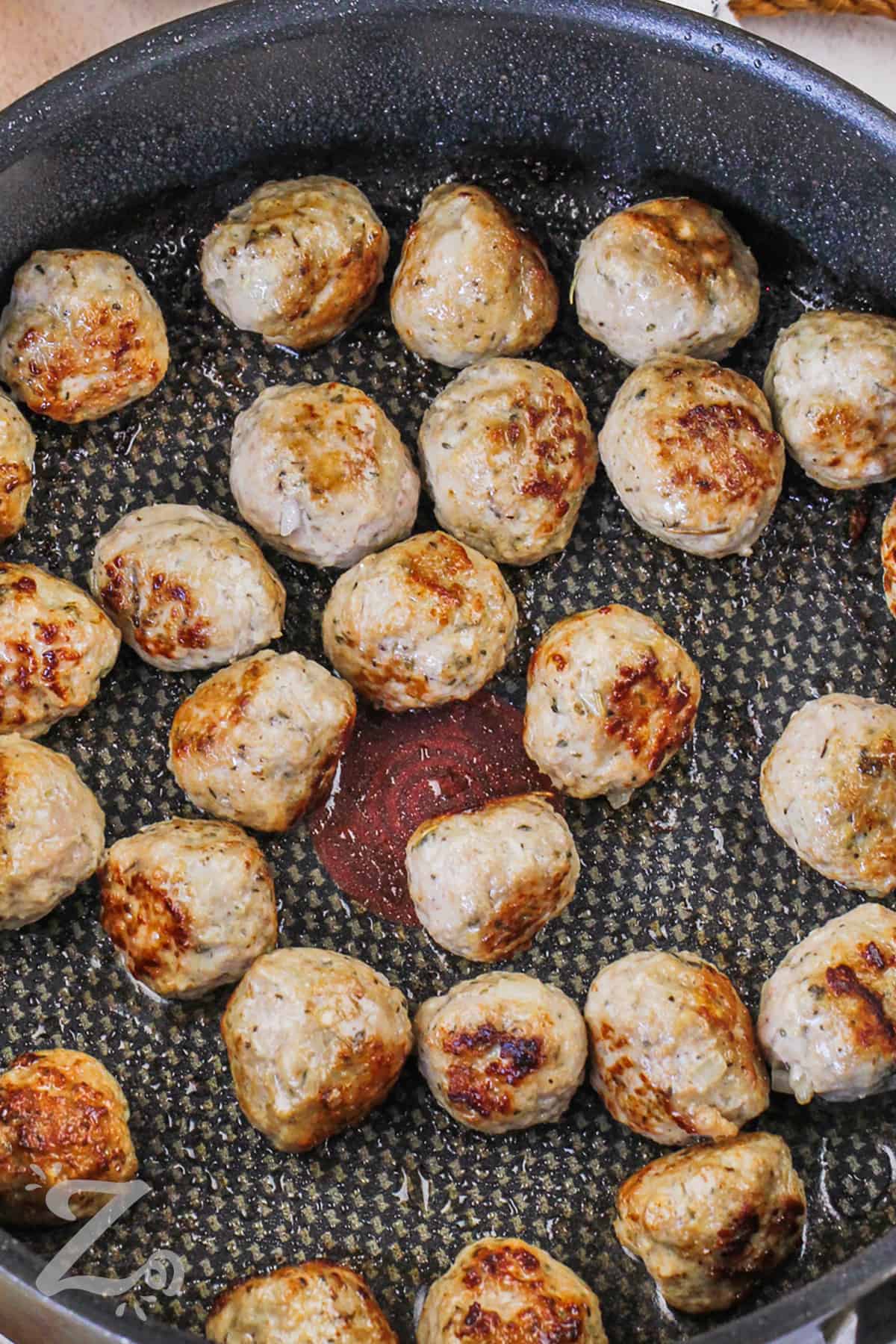 cooked Chicken meatballs in a frying pan