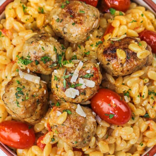 Chicken meatballs in a bowl with pasta and tomatoes