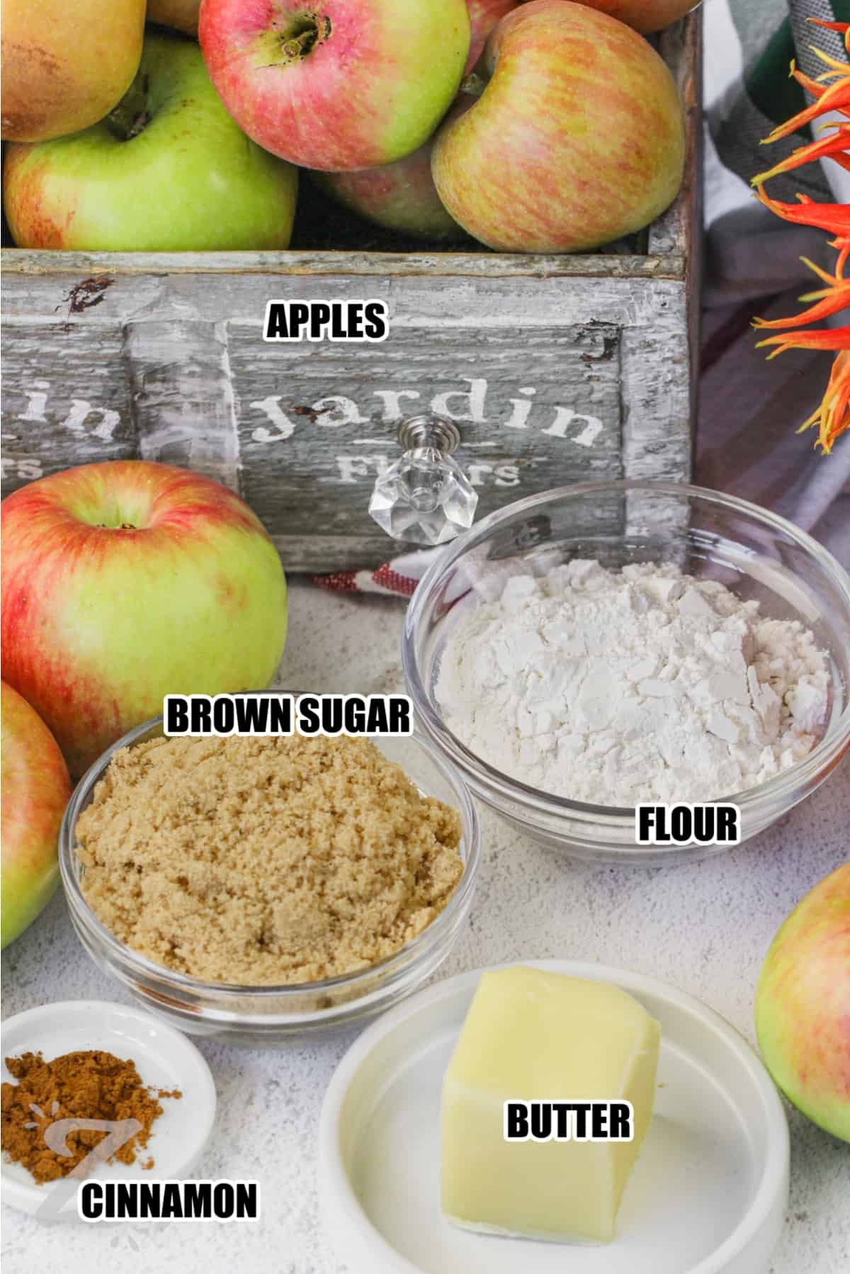 ingredients to make Apple Crumble including brown sugar, apples, butter, flour, and cinnamon